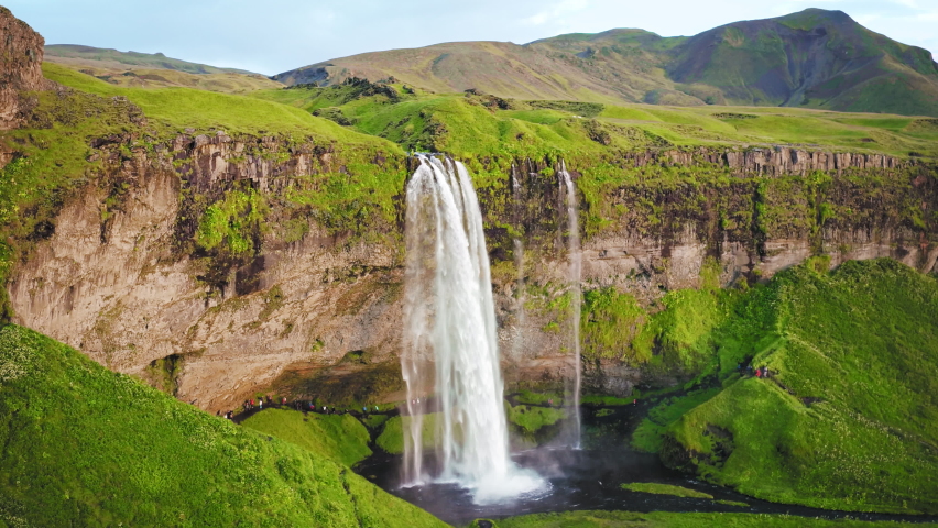 Waterfall Mountain Travel Summer Spring Autumn Epic Drone Shot Around Famous Waterfall In Iceland Water Flowing Through High Cliffs Inspiration Epic Scale Nature Sight Seeing Royalty-Free Stock Footage #1060347764