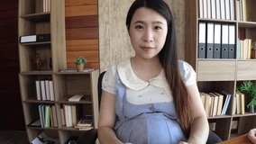 Asian pregnant woman live web camera online to sale red canvas shoes for kid baby. 