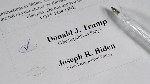 KYIV, UKRAINE - SEPTEMBER 10, 2020: Voice for Republican Party candidate Donald Trump in paper ballot on US Elections with pen. 2020 presidential election. Loss Democratic Joe Biden