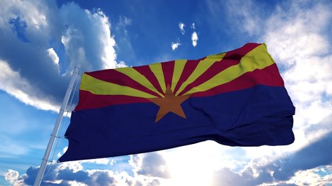 Arizona flag on a flagpole waving in the wind in the sky. State of Arizona in The United States of America