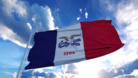 Iowa flag on a flagpole waving in the wind in the sky. State of Iowa in The United States of America