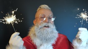 Happy Funny Emotional Santa Claus Sings Song Enjoying Music, Dances Playing with Magical Sparklers, Looking at Camera Closeup Indoors. Positive Festive Mood at New Year, Christmas Holidays Celebration - Powered by Shutterstock - Get 15% off with code: PIKWIZARD15