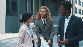 Confident businessman leader meeting his two diverse friends throwing papers away leaving corporate office rejoicing freedom, carefree life and new opportunities. - Powered by Shutterstock - Get 15% off with code: PIKWIZARD15