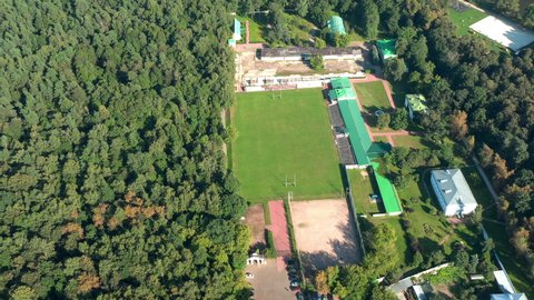 Rugby's pitch inside the park. Small stadium in circle view from above,