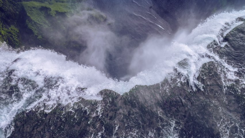 Waterfall Edge Fly Over Landscape Epic Aerial Flight Around Famous Waterfall In Iceland Water Flowing Through High Cliffs Inspiration Epic Scale Nature Epic Adventure Royalty-Free Stock Footage #1060362032