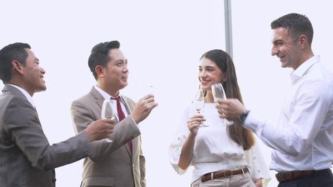group of successful executive business team drinking and talking to celebrate. Diverse business people have party together at outdoor skyscraper.