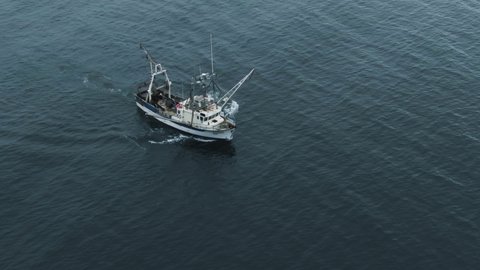 Fishing Trawler Heads Out And Sailing On The Calm Waters Of Saint Lawrence River In Quebec, Canada. - aerial drone shot