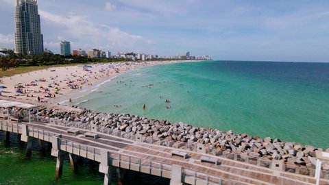 Aerial view away from the South Pointe Park Pier and the Miami beach,on a sunny day, Florida, USA - reverse, drone shot