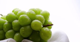 Muscat grapes on a turntable and video recording.
White background.