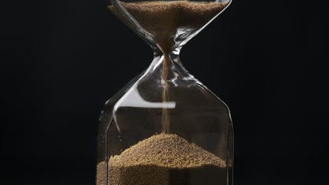 Sand is pouring in the hourglass. Time is up