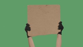 Hands in black gloves pick up a blank poster from a cardboard box. Blank space for your slogan, logo or advertisement. Banner design concept. Isolated a green screen, chroma key. Close up. Slow motion - Powered by Shutterstock - Get 15% off with code: PIKWIZARD15