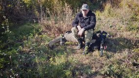 A hunter with a crossbow at a halt drinks coffee. - Powered by Shutterstock - Get 15% off with code: PIKWIZARD15