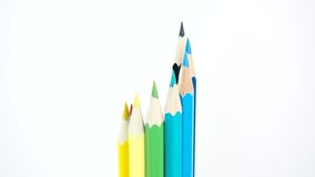 Colored wooden pens with a white background make a twist
