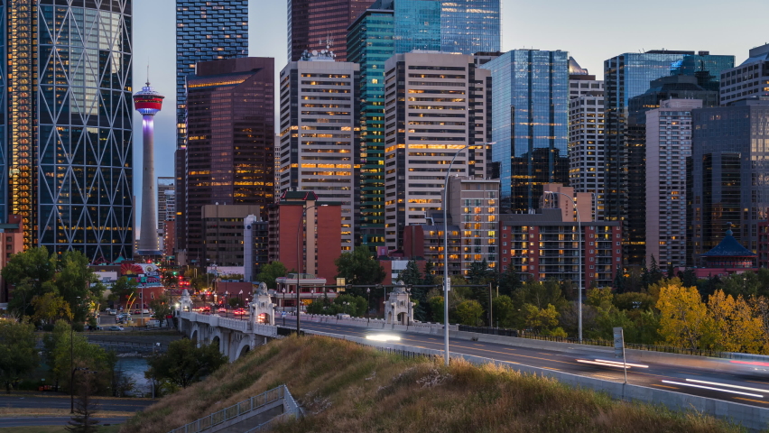 Day to night zoom in time lapse sequence showing traffic and modern high rise buildings in Downtown Calgary, Alberta, Canada. Royalty-Free Stock Footage #1060380323