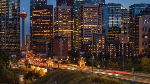 Day to night zoom in time lapse sequence showing traffic and modern high rise buildings in Downtown Calgary, Alberta, Canada.