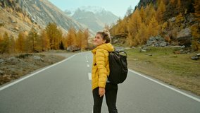 Camera follows woman on trip or adventure. Young millennial traveller or travel blogger walk in beautiful mountain valley and make photos for social media or memories. Generation z new concept travels - Powered by Shutterstock - Get 15% off with code: PIKWIZARD15