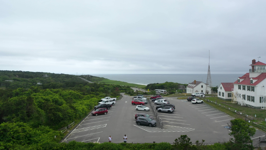 Aerial Drone Shot of Parking Lot next to Ocean on Dark Cloudy Day in Cape Cod, Massachusetts, Pan Right