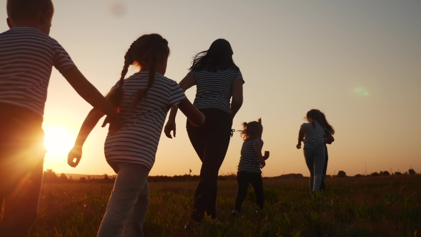children happy family kid together run in the park at sunset silhouette. people in the park concept. mom daughter and son joyful run. happy family and little baby child summer kid fun dream concept Royalty-Free Stock Footage #1060394273
