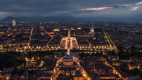 Establishing Aerial View Shot of Turin IT, Mole Antonelliana on the horizon, Torino Skyline, Italy at night evening