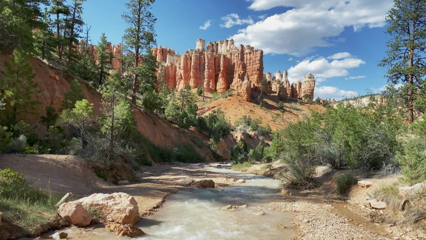 Peaceful creek winds through red sandstone cliffs along the Moss Cave Trail in Bryce Canyon National Park, Utah, USA. Static shot.