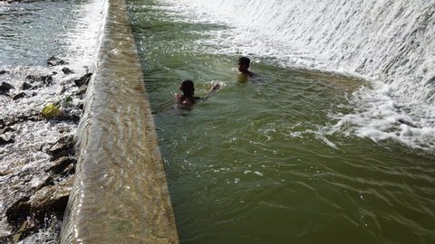 Indian boy swimming in the river in the village of Ambegaon,city Aurangabad, Maharashtra, India,on date 5 October 2020 at 7.32pm