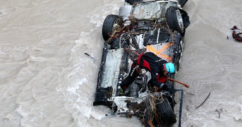Breil-Sur-Roya, France - October 8, 2020: Rescuer Removing Debris On A Car In The Roya River After Flooding During Storm Alex, Breil-Sur-Roya City In The South Of France, Europe - DCi 4K Resolution