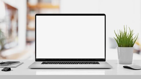 Laptop with blank screen smooth zoom in - white table with mouse and smartphone. Home interior or office background, 4k 30fps UHD
