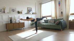 Young Woman doing balance exercise and Stretching sports Yoga, Black Sportswear Leggings and Top, bright room At home in the Morning. - Powered by Shutterstock - Get 15% off with code: PIKWIZARD15
