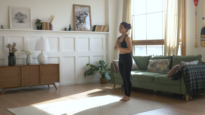 Young Woman Doing Meditation Exercise Stretching Sports Yoga, Clothes Black Leggings and tube Top, Bright Room at Home. | Shutterstock HD Video #1060427788