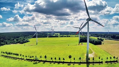 Aerial view of summer countryside with wind turbines and agricultural fields. Full HD, 1080p
