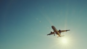 Large airliner with passengers on blue sky is landing on landing strip at airport of bright orange sunset on sunny summer day. Go Everywhere. Airplane flies in sky at sunset day lens flares. Travel - Powered by Shutterstock - Get 15% off with code: PIKWIZARD15