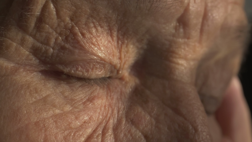 senior woman eyes, wrinkled face. portrait of old european grandmother with green eyes. old skin with wrinkles. close up of wrinkled face of Caucasian woman. Royalty-Free Stock Footage #1060434586