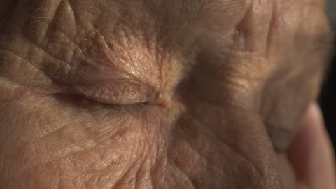 senior woman eyes, wrinkled face. portrait of old european grandmother with green eyes. old skin with wrinkles. close up of wrinkled face of Caucasian woman.