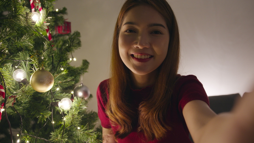 Young Asia female using smart phone video call talking with couple with X