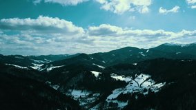 Winter snow-covered Carpathian mountain range of the top of the mountains covered with snow aerial video 4K.