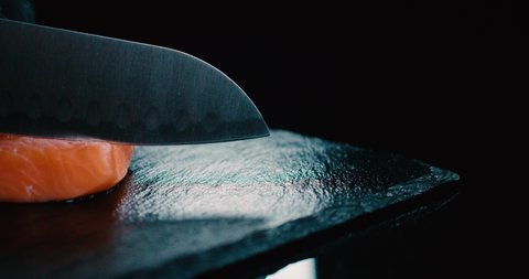 Sushi Chef Cutting piece of salmon with silver knife  4K