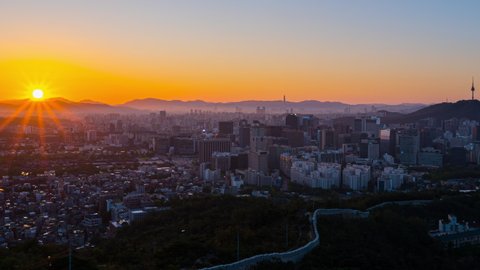 Zoom out,Time lapse Landscape of Seoul South Korea in the morning and the golden sun shines on the city.