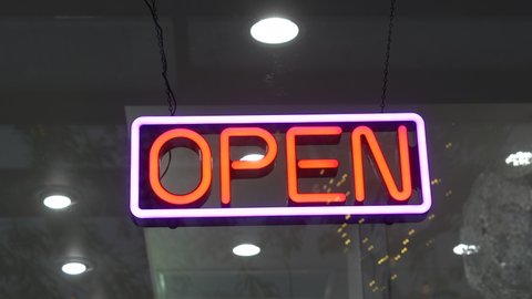 Open Neon store sign welcoming customers.