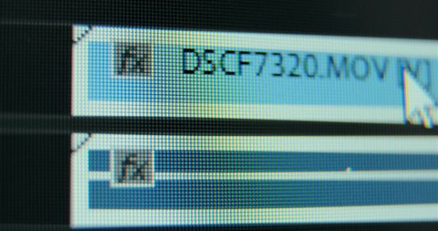 Film editor cuts beginning of footage fulfilling installation on timeline in contemporary computer program extreme close view