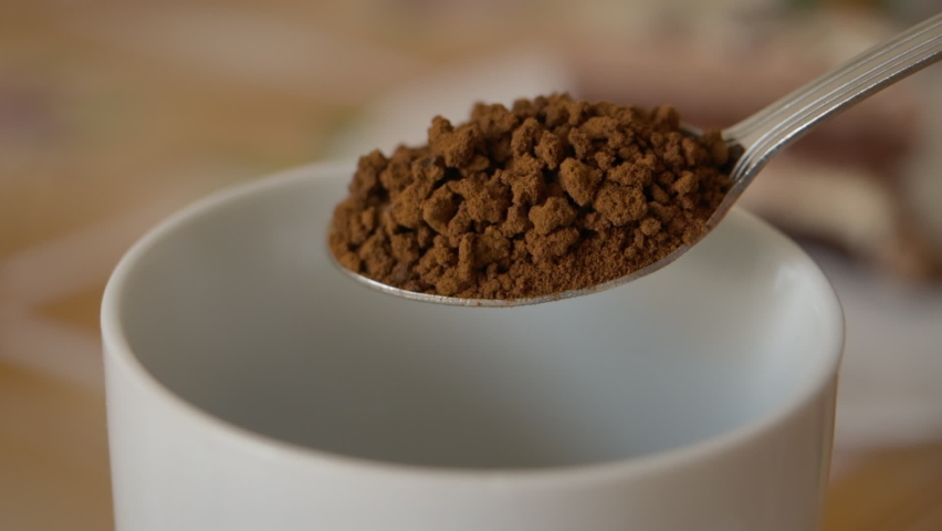 Instant Coffee Pieces Falling From Spoon in Slow Motion in Cup. Fresh Morning Hot Chocolate Close Up. Slow Motion. Coffee Powder Falling From Spoon. Closeup Morning Cocoa. Royalty-Free Stock Footage #1060460323