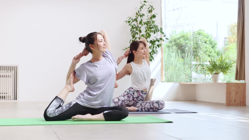 Asian woman doing yoga indoor Royalty-Free Stock Footage #1060460434