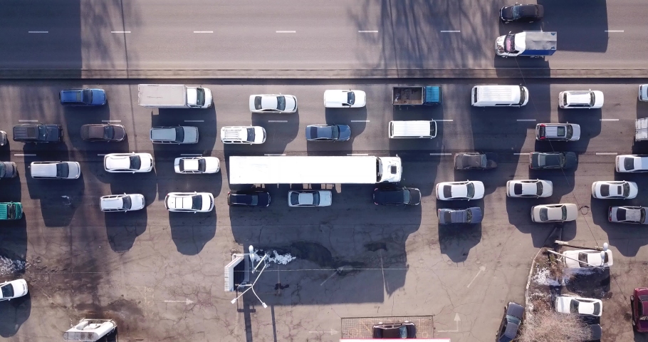 Transport interchange in a big city. Long traffic jam. A huge number of cars pass by. A large trucker's truck is visible. Muddy roads, heavy car exhaust. Bad ecology of the city of Almaty. Royalty-Free Stock Footage #1060466521