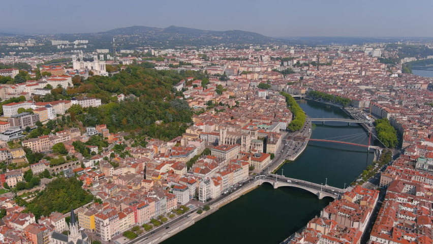 Lyon: Aerial view of historic city with hilltop Basilica of Notre-Dame de Fourviere (La Basilique Notre Dame de Fourviere) - landscape panorama of France from above, Europe Royalty-Free Stock Footage #1060467142