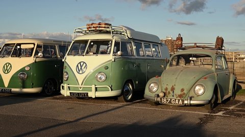 Littlehampton, West Sussex, UK, October 11, 2020. Old Volkswagen vehicles footage of two VW Camper Vans and a Beetle parked in a car park.