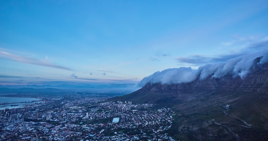 4k right to left panning time elapse of rolling clouds over table top mountain at dusk and the city of Cape Town just before dark,South Africa
