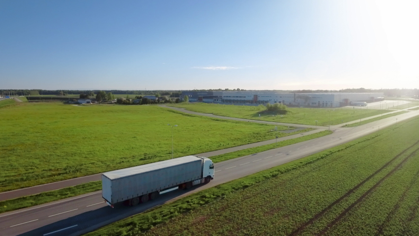 Futuristic High-Tech Concept: Big Semi Truck with Cargo Trailer Drives on the Road is Transformed with Graphics Special Effects Into Digitalized Advanced Autonomous Truck Concept. Aerial Drone Shot Royalty-Free Stock Footage #1060479190