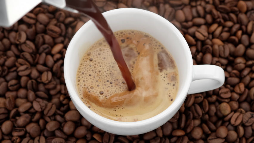 Pouring black coffee in cup. top view of coffee pour into cup from geyser coffee maker. coffee with froth | Shutterstock HD Video #1060480036