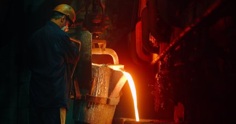 The worker pours in the form of hot metal. Metalworks