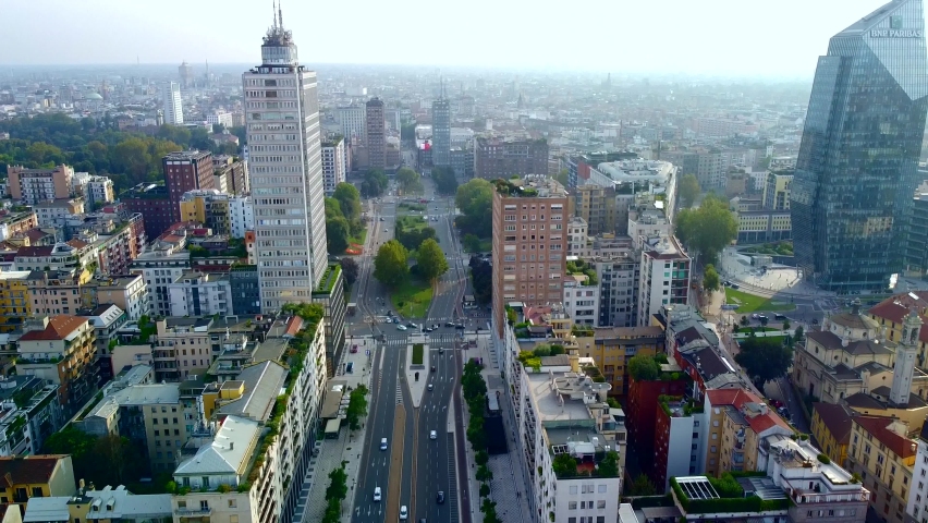 Aerial view of the long boulevard Via Vittor Pisani in front of the central train station. Roofs of houses. Piazza Duca d'Aosta. Empty asphalt street. Pov. Milan. Italy, 09.23.2020 | Shutterstock HD Video #1060485892