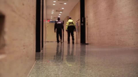 Security guards walking down hallway
